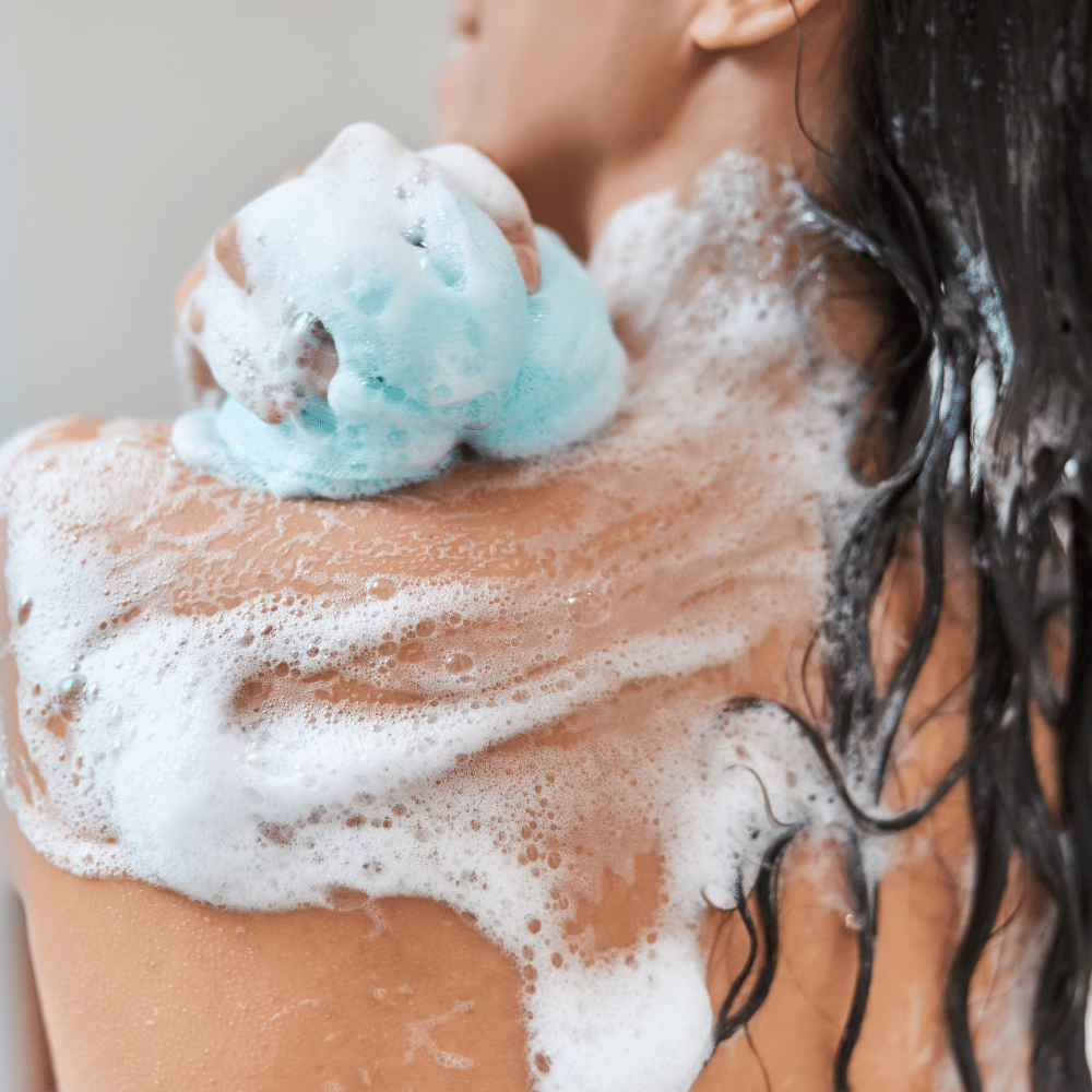 Girl using best exfoliating body sponge